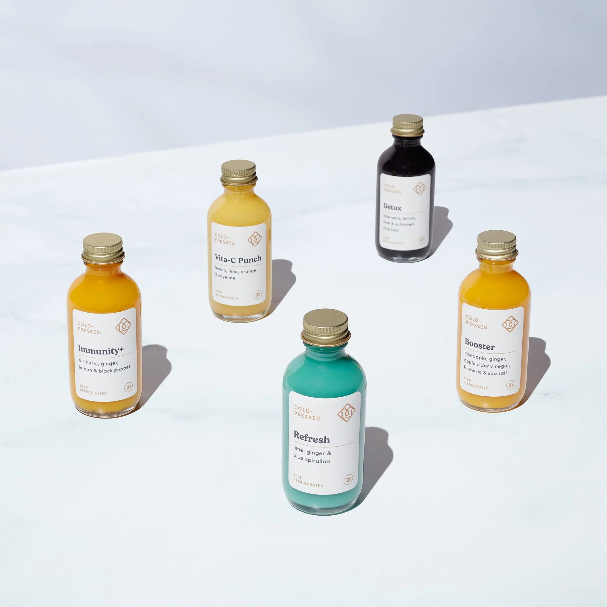 Toastique wellness shots including Immunity, Booster, Detox, and Vita-C Punch on a counter.