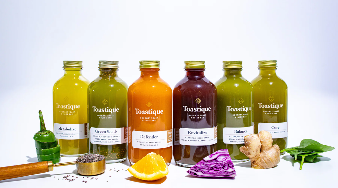 Toastique’s full line of cold-pressed juices displayed with fresh produce ingredients, representing the vibrant, health-driven menu that powers successful juice bar franchises across top U.S. cities.