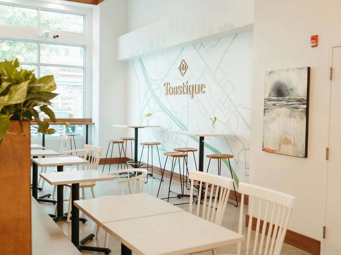 Bright and modern Toastique acai bowl franchise café interior with natural light, clean design, and welcoming seating.