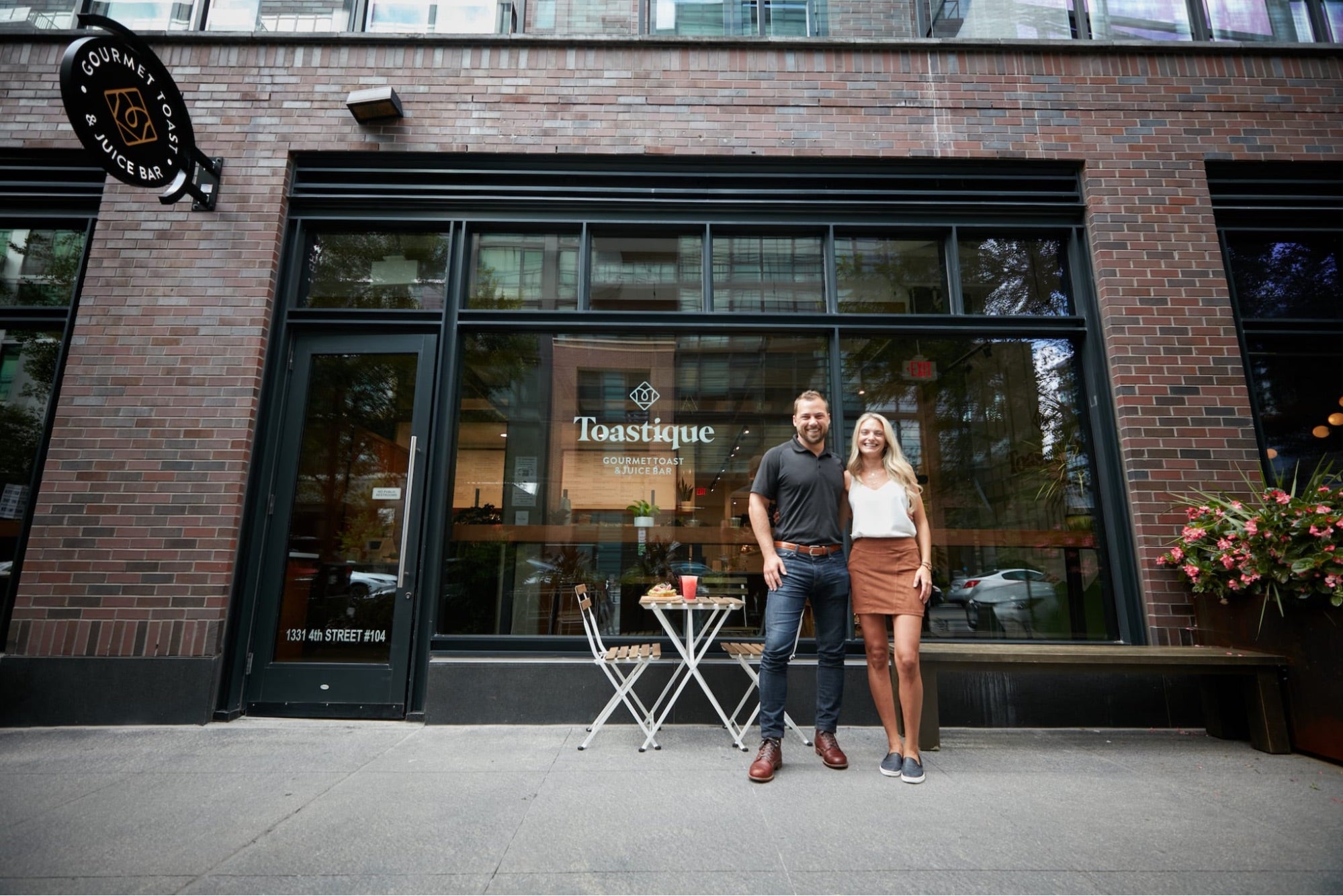 Toastique franchise owners standing proudly outside their café, representing weekend brunch franchise ideas that become community favorites.