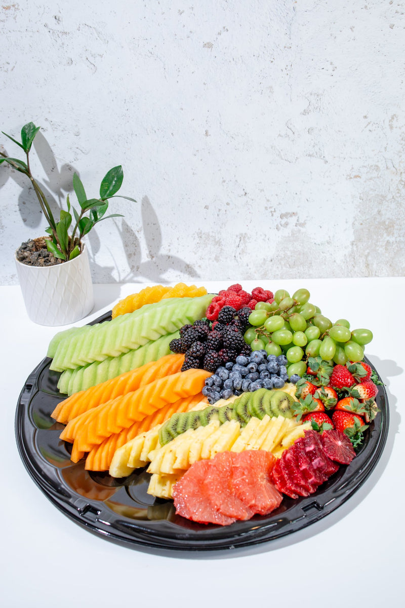 Fresh fruit platter with melon, berries, grapes, kiwi and pineapple