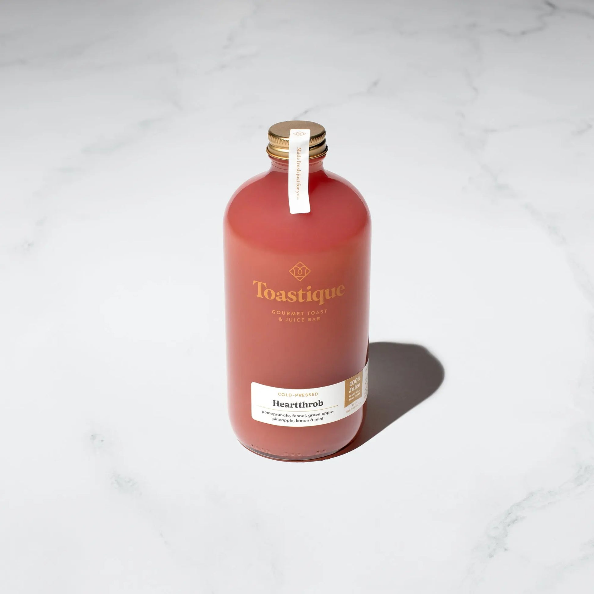 A glass bottle of Toastique's Heartthrob Cold-Pressed Juice.