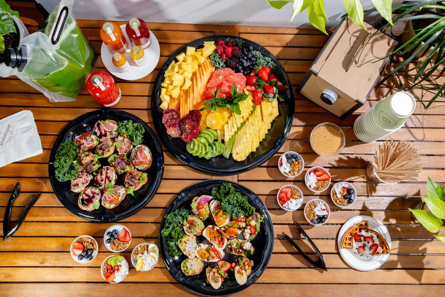 A Toastique fresh fruit platter arranged on white marble
